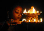 A girl lights lamps on the occasion of Diwali 