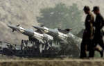 Indian soldiers walk past missiles positioned close to the border with Pakistan near Amritsar. Reuters/Arko Datta