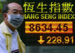 A man wearing a mask walks past Hang Seng Index display in Hong Kong on March 31. Reuters/Bobby Yip 