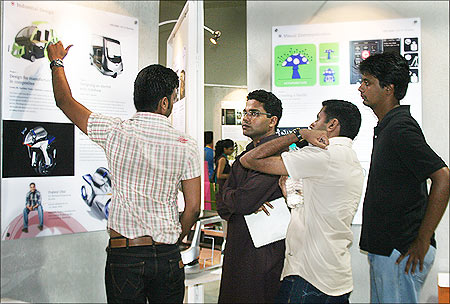 An IDC student explains his project to visitors