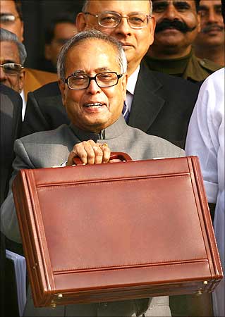 Finance Minister Pranab Mukherjee smiles as he leaves his office to present the 2009/10 interim Budget