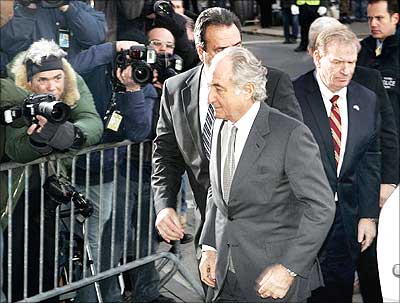 Accused swindler Bernard Madoff (front) enters the Manhattan federal court house in New York.