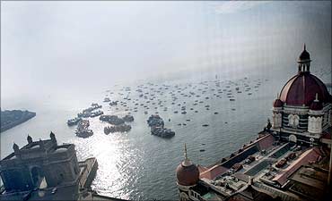 The domes of the Taj Mahal hotel and the historic Gateway of India (L).