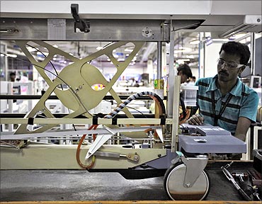 GE Healthcare employee assembles a CT scan table in Bangalore.
