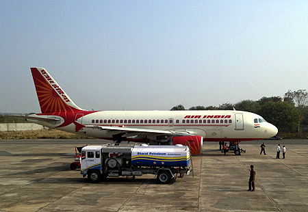 A Bharat Petroleum refuelling vehicle sits on the tarmac next to an Air India A320 aircraft as it refuels the plane with jet fuel in Gwalior.