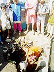 Children collecting water from a pit in Phaltan