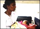 A village nurse with a baby saved from infanticide