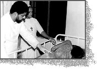 Father Varghese treating an Aids patient