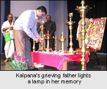 Kalpana's grieving father lights a lamp in her memory