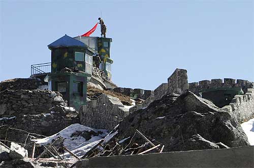 A Chinese soldier put up a flag atop their post at the India-China trade route at Nathu-La Pass