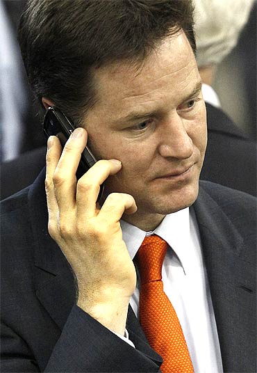 Liberal Democrat party leader Nick Clegg talks on phone