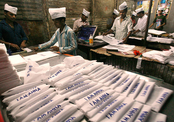 In New Delhi workers print Anna Hazare caps