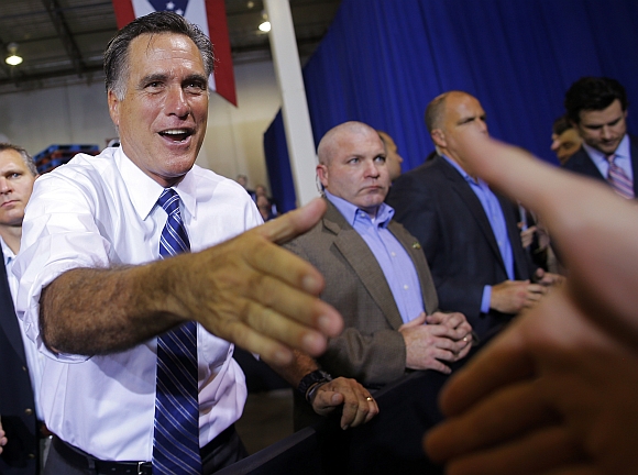 US Republican presidential nominee Mitt Romney greets audience members at a campaign stop at Jet Machine in Cincinnati