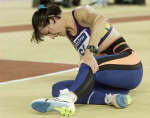 Louise Currey grabs her injured leg during trials