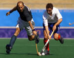 Pakistan's Mohammad Shafqat (L) and Britain's Jimmy Wallis fight for the ball. REUTERS/Jason Reed 
