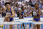 Gail Devers walks out after hitting a hurdle