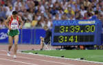 Nourredine Morceli limps toward the finish line after falling. REUTERS/Ian Waldie 