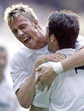Real Madrid's Raul Gonzalez (R) is congratulated by Guti