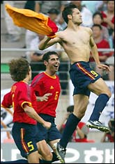 Fernando Morientes (R) leaps in celebration in front of team mates Fernando Hierro (C) and Carles Puyol after scoring 