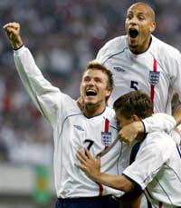 England's captain David Beckham (L), Rio Ferdinand and Michael Owen (R) celebrate Owen's goal. 