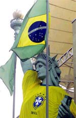 A replica of the Statue of Liberty is adorned with a Brazilian national soccer team jersey