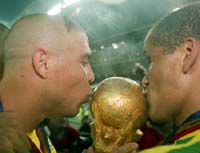 Ronaldo and Rivaldo kiss the coveted FIFA World Cup.
