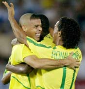 Brazil's Ronaldo (L) celebrates with team mates Ronaldinho (R) and Roque Junior (C) after scoring his first goal.