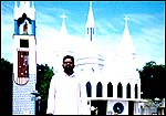 Father Muthuswamy outside the Church of Apparition