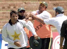 Younis Khan (L) and Inzamam ul Haq (2nd R) are separated by Saeed Anwar (2ndL) and an unidentified teammate