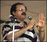 Mohan talks to the audience before the play 