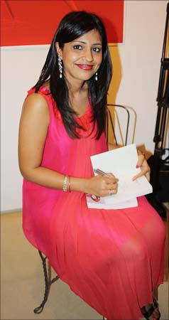 Amrita signs a copy of <I>Faking It</I>