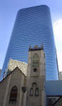 The tower of one of  Enron's three downtown Houston office towers looms over the historic Antioch Baptist Church on November 29, 2001. Reuters/Richard Carson