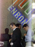 Visitors to the Enron building don security badges
