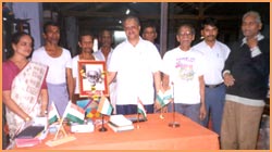 A proud and humble Bhatt poses with the workers at his flag unit