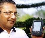 Vinay L Deshpande Chairman, CEO and founder of Encore Software seen posing with Simputer. Photo: Reuters/Str