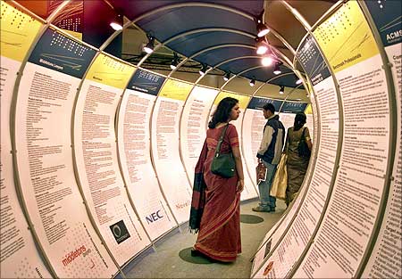 Indians look at IT posters during the seventh edition of the IT industry exposition.