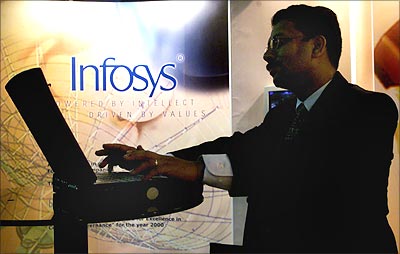A visitor works on a laptop at a stall advertising Infosys.