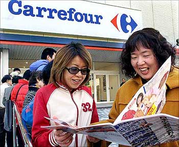 Japanese women wait for grand opening of Carrefour in Makuhari.