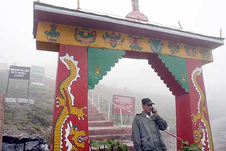A soldier stands at the gate near Nathu La