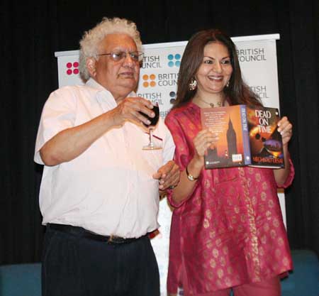 Lord Desai poses with a glass a wine and a copy of Dead on Time