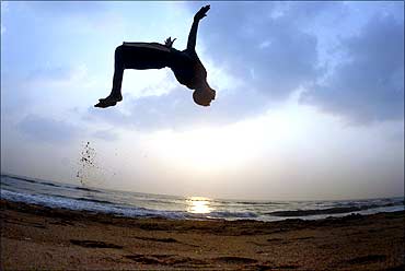 A boy somersaults at Marina beach as part of his routine morning exercise in Chennai.