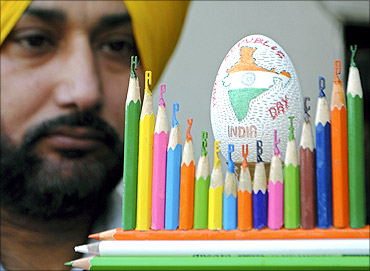 Harwinder Singh Gill, an artisan, displays his creation of an Indian map carved on an eggshell.