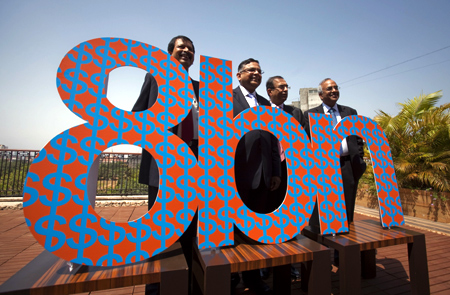 N. Chandrasekaran (2nd L), Chief Executive of Tata Consultancy Services (TCS), poses for a photo with members of his management team before a news conference to announce the company's Q4 results in Mumbai April 21, 2011.