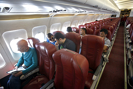 Kingfisher Airlines passengers sit on a plane after takeoff from Mumbai's domestic airport.