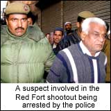 A suspect involved in the Red Fort shootout being arrested by police