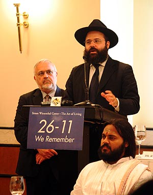 Rabbi Berkowitz speaks at the Inter-Faith conference at the Trident Hotel, with Rabbi Abraham Cooper (behind) and Swami Gnanatej looking on