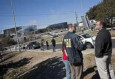 FBI personnel talk to people near the site