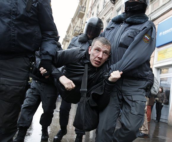 Security forces detain an anti-government protestor in Moscow on Saturday