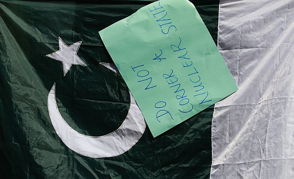 A placard hangs on a Pakistan flag during a protest against the NATO air strike in Pakistan last month