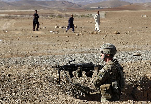 A US army soldier takes position during a cooler storage utilisation assessment mission in Logar province of Afghanistan